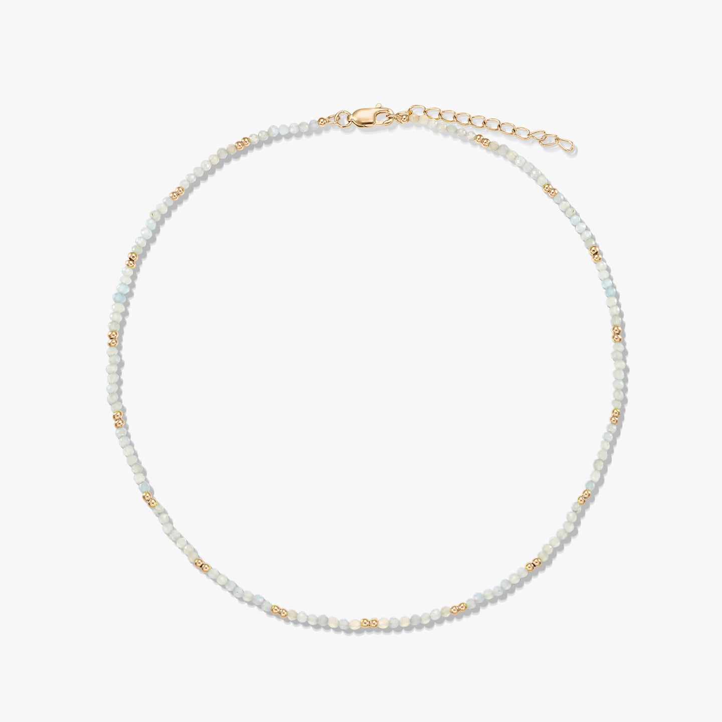 Delicate beaded moonstone necklace featuring small gold spacer beads and a gold‑plated sterling silver lobster clasp and extender, arranged in a circle on a white background.