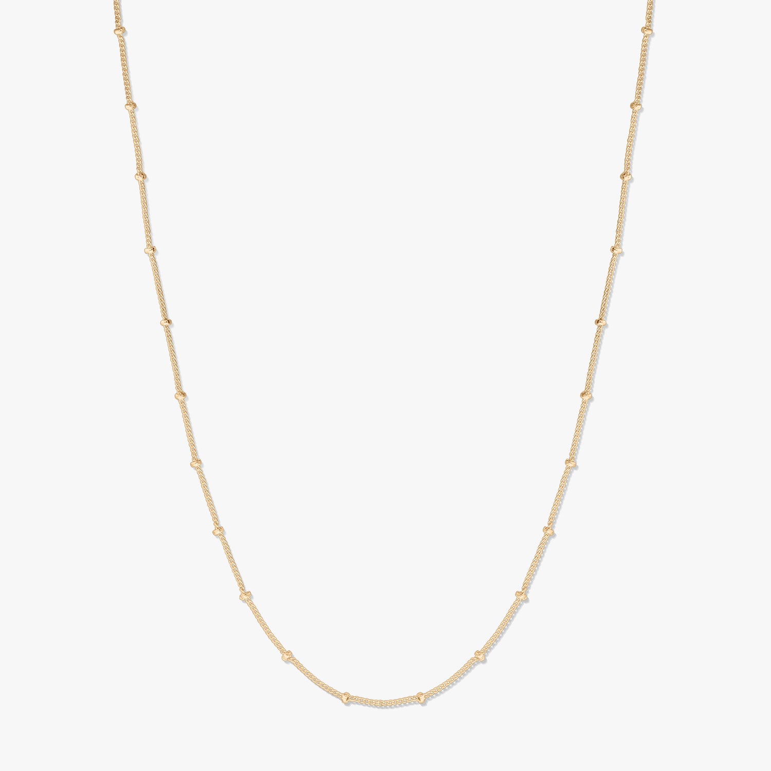 Elegant gold-plated silver beaded chain necklace on a white background, forming a gentle U-shape with delicate bead stations along the chain.