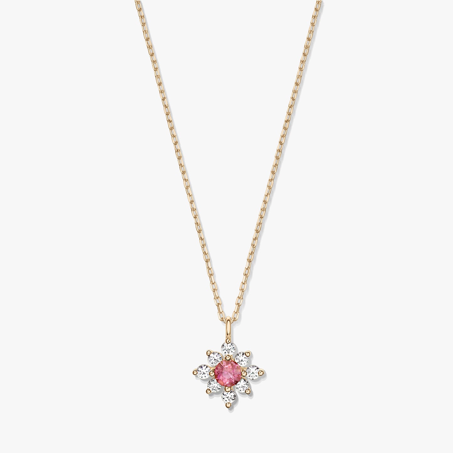 Collier en or 14K avec pendentif floral, centre en tourmaline rose entouré de saphirs blancs, sur fond blanc.