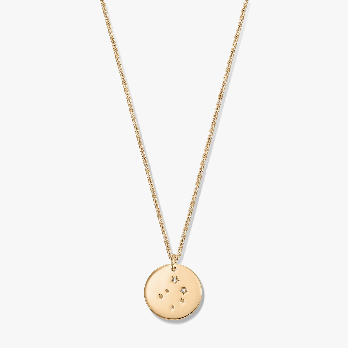 Gold‑tone Libra constellation disc pendant on a fine chain, photographed on a white background.