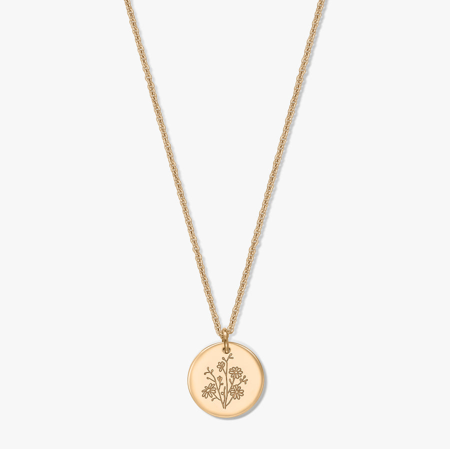 Gold-plated silver necklace featuring a delicate rope chain and a round coin pendant engraved with an aster birth flower, isolated on a white background.