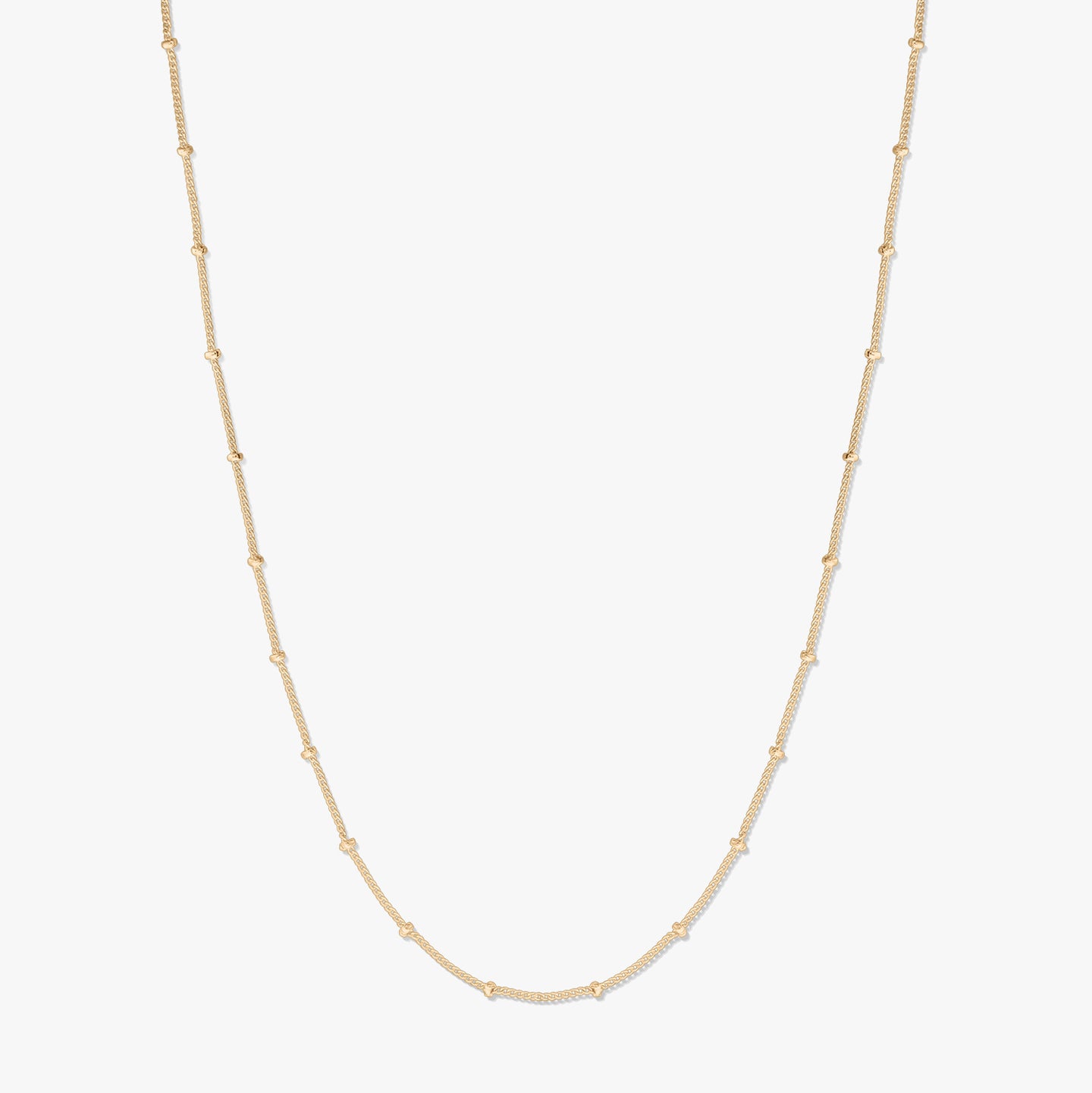 Elegant gold-plated silver beaded chain necklace on a white background, forming a gentle U-shape with delicate bead stations along the chain.