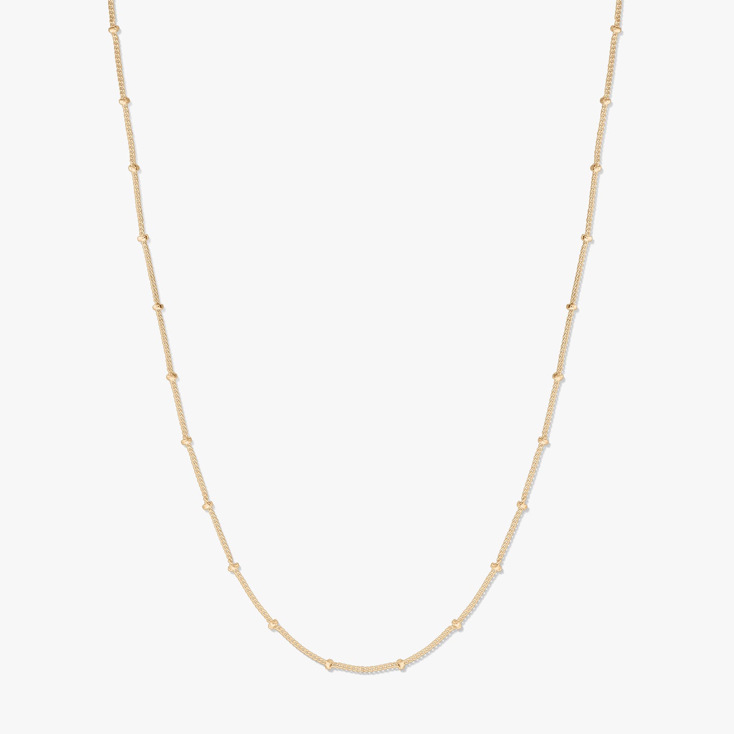 Elegant gold-plated silver beaded chain necklace on a white background, forming a gentle U-shape with delicate bead stations along the chain.