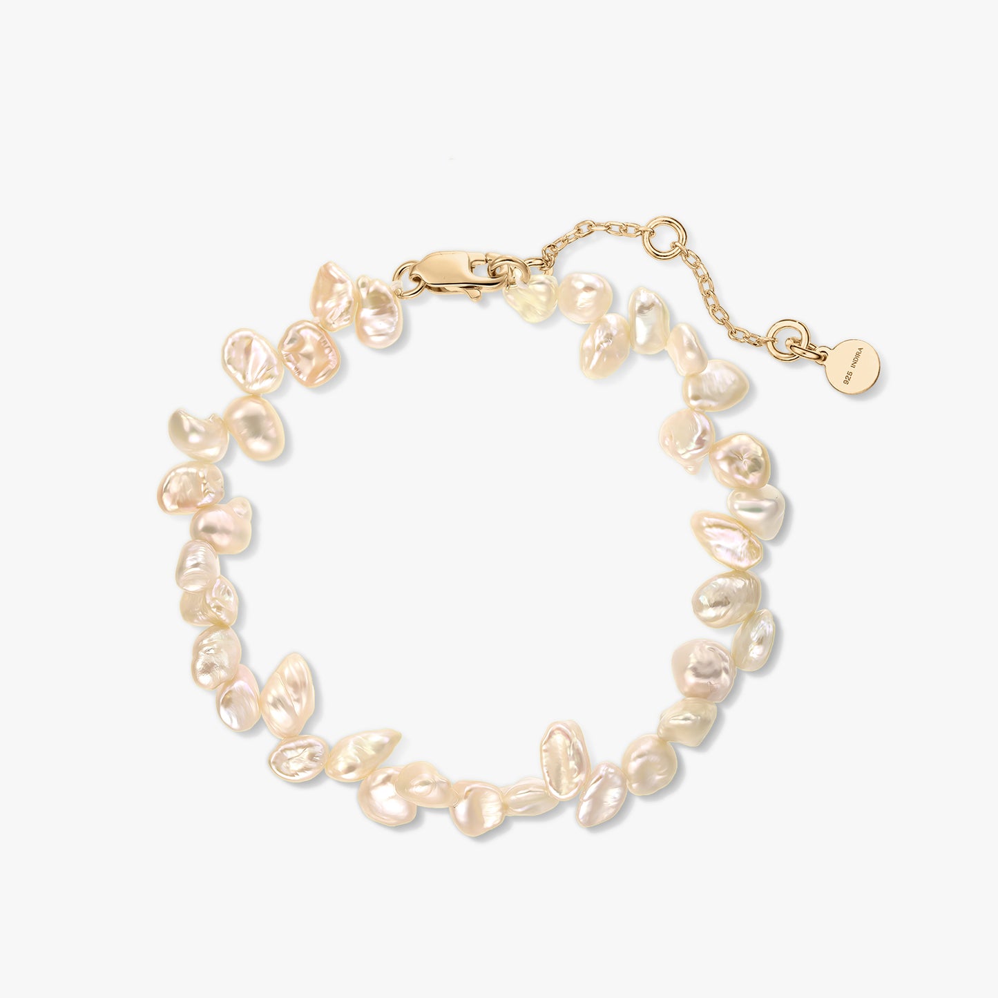 Gold-plated sterling silver bracelet with natural pink keshi pearls and an extender chain on a white background.