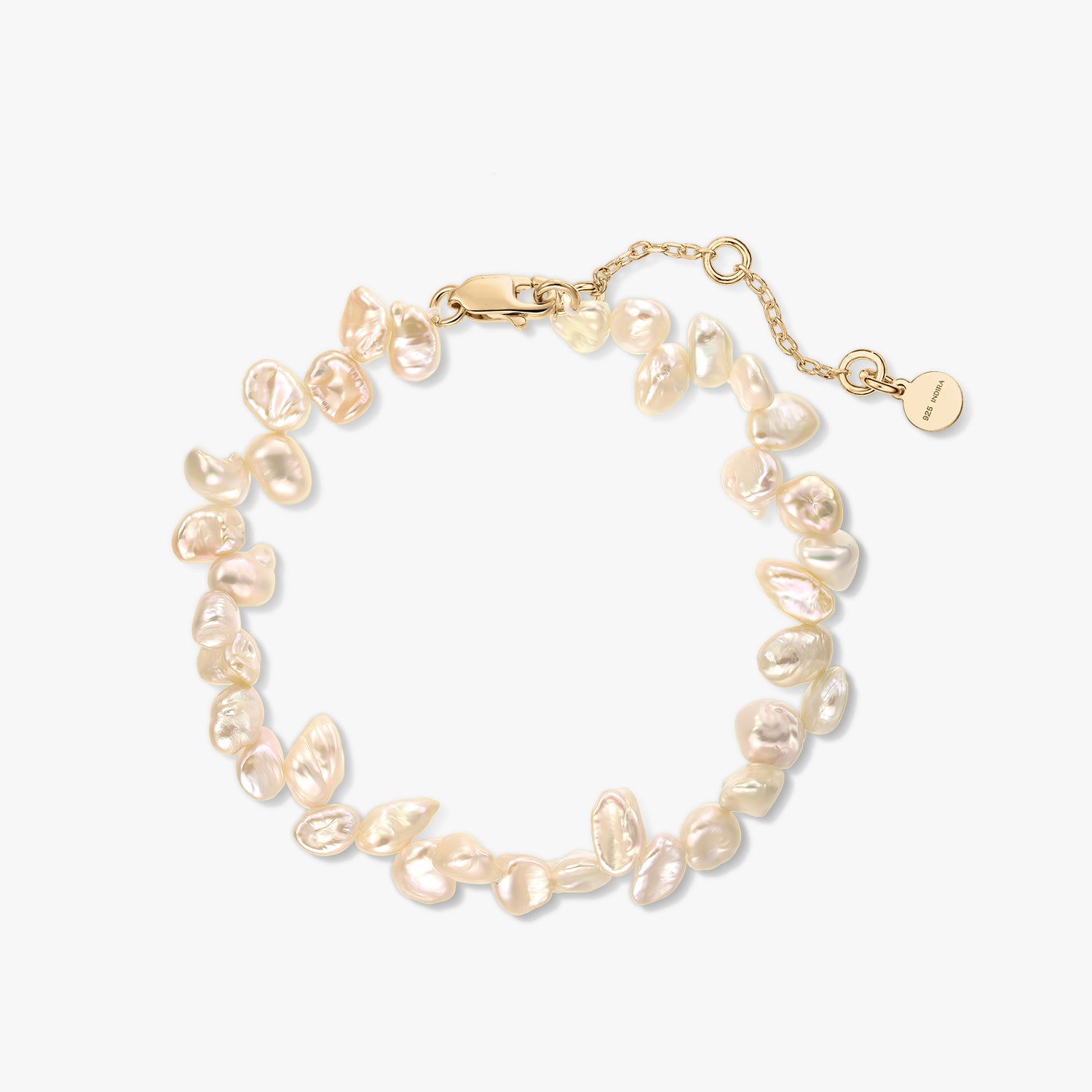 Gold-plated sterling silver bracelet with natural pink keshi pearls and an extender chain on a white background.
