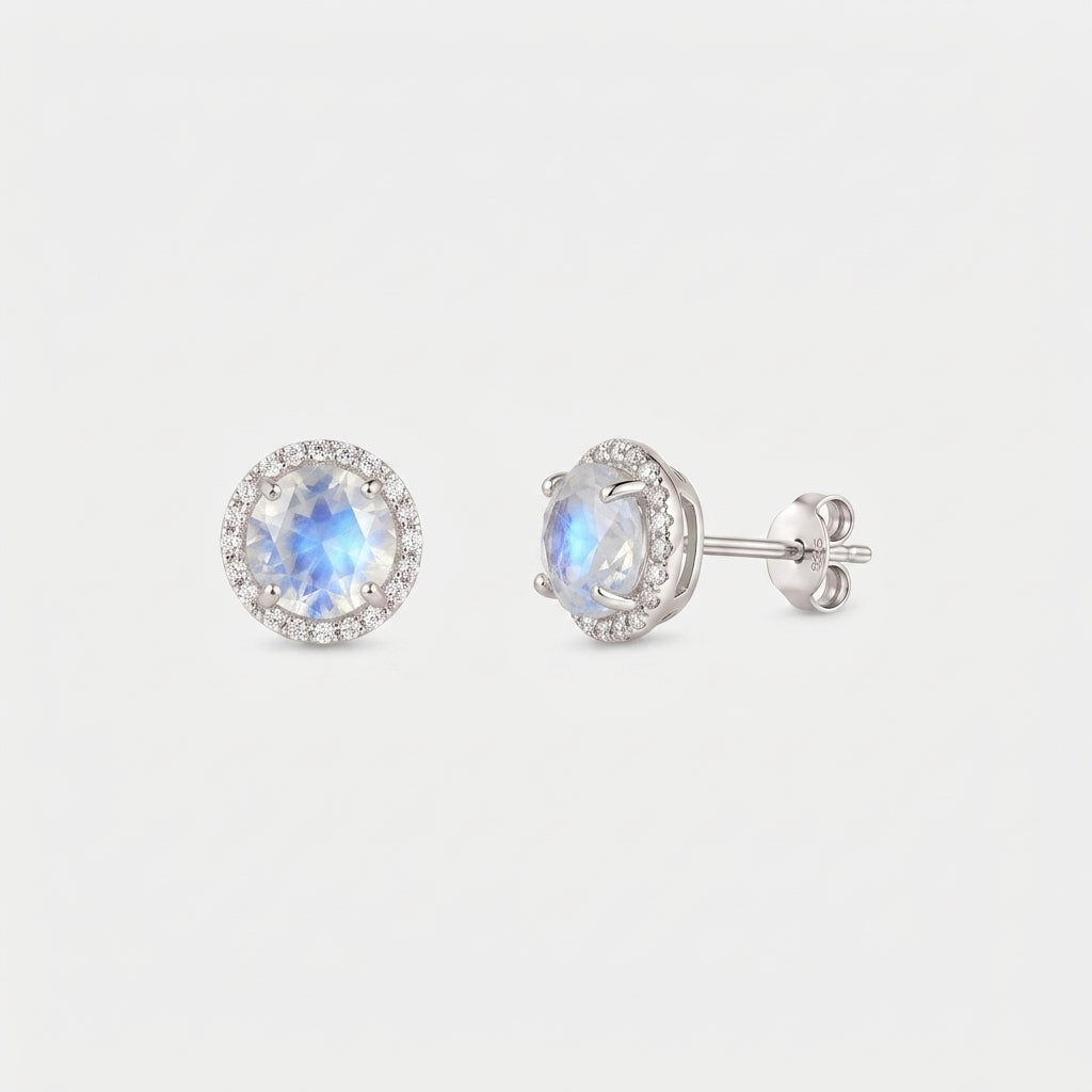 Pair of Keira moonstone halo stud earrings in 925 sterling silver, shown front and side with butterfly backs on a white background.