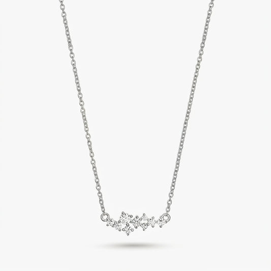 Delicate silver constellation necklace with small clear stones on a fine chain, isolated on a white background.