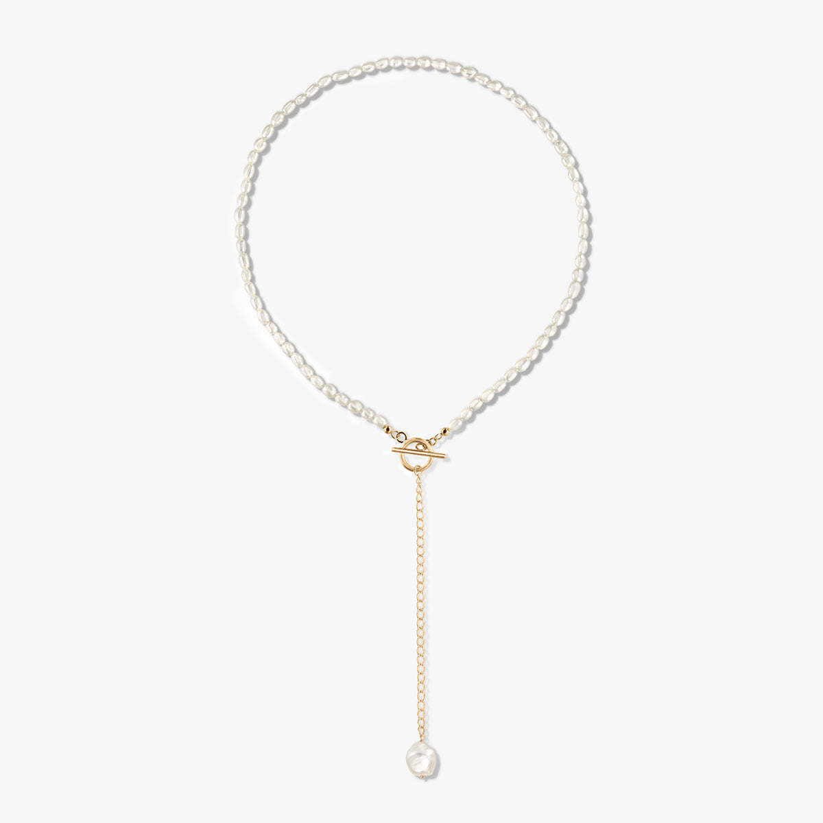 Golden Jacqueline 14K gold-plated sterling silver pearl necklace featuring a front toggle clasp and a gold drop chain ending with a single pearl, displayed on a white background.
