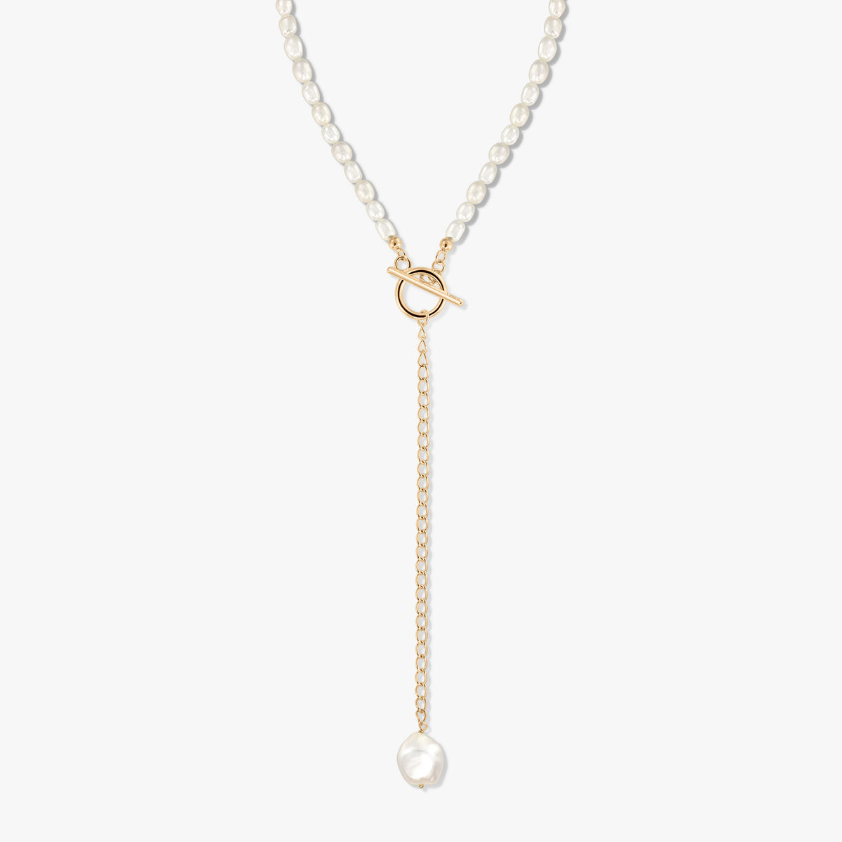 Silver Y-necklace gold-plated with a strand of cultured pearls, front toggle clasp, and a dangling chain ending in a baroque pearl on a white background.