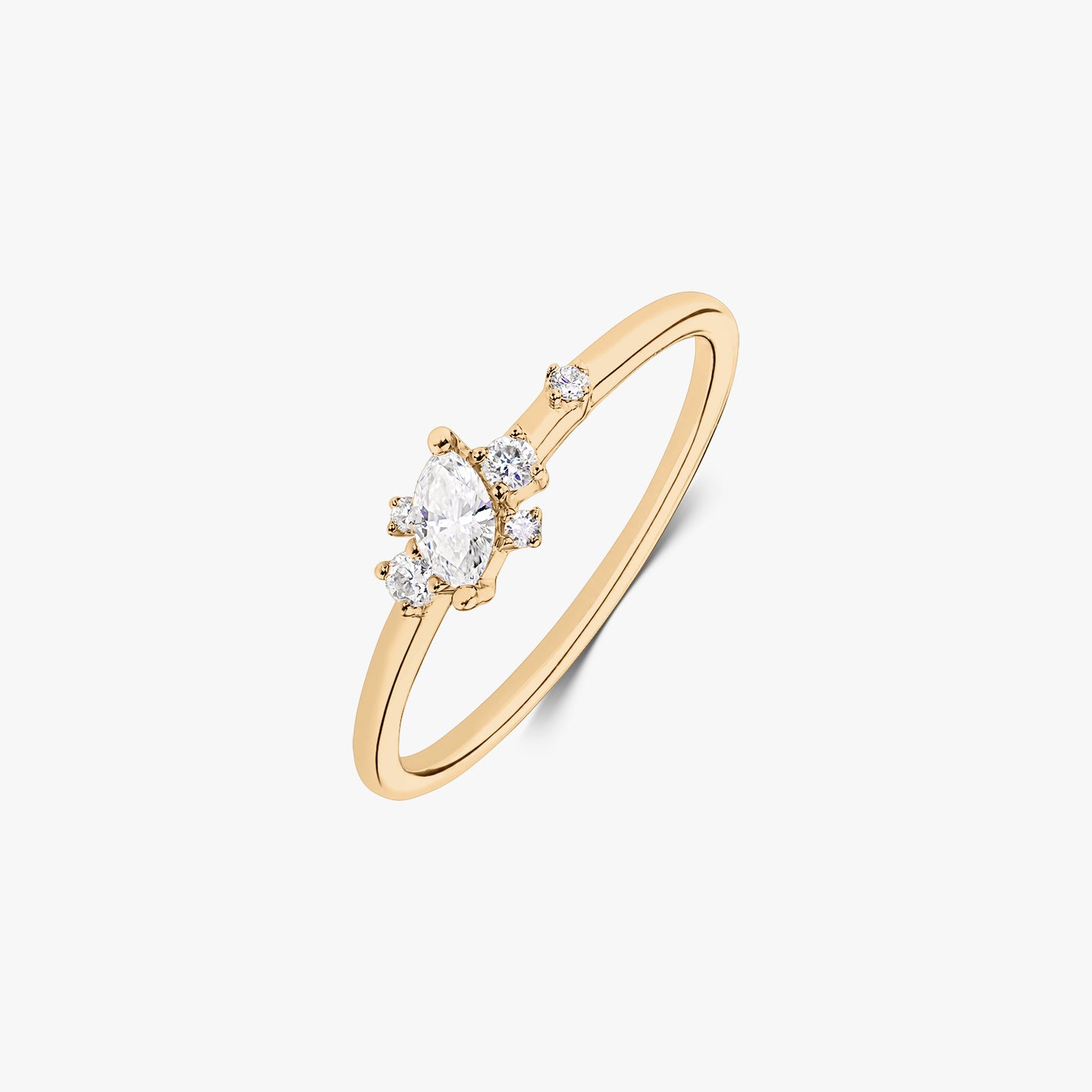 Elegant 14k yellow gold ring featuring a marquise-cut center diamond and small round accent diamonds on a slim band, isolated on white.