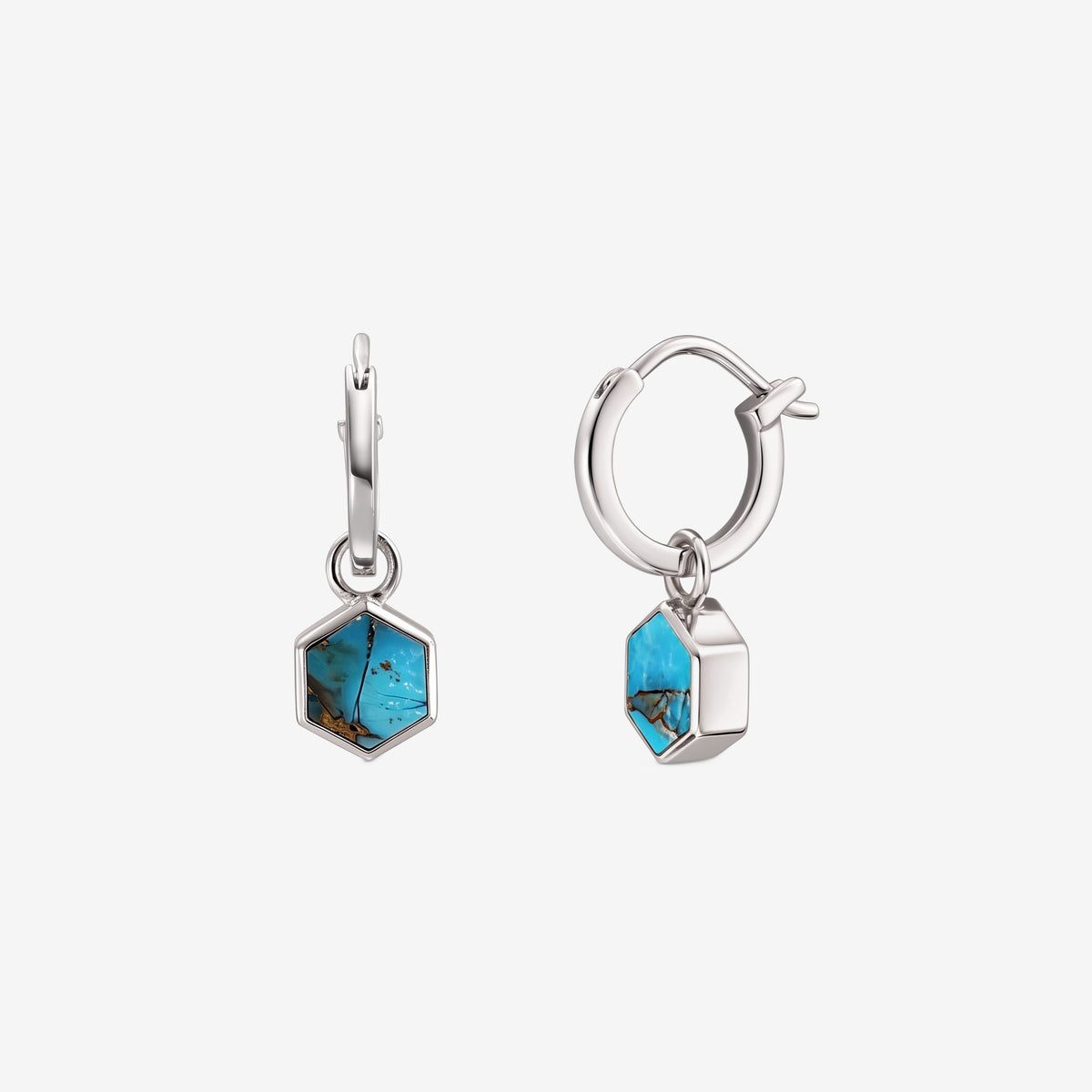 Front and side views of the Charlotte Silver Earrings: 925 sterling silver huggie hoops with hexagon turquoise blue copper stone charms on a white background.