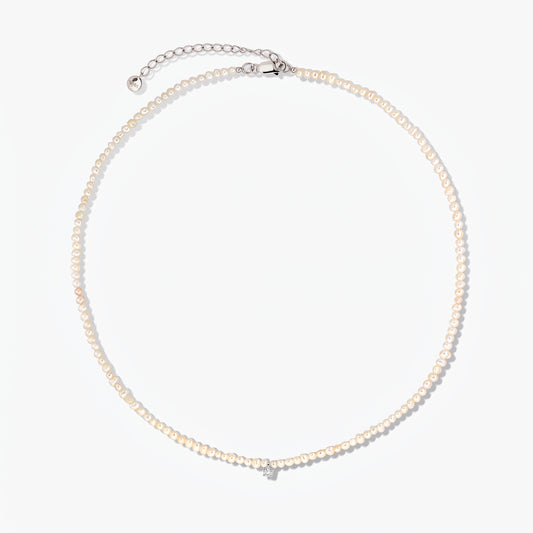 Fairy silver necklace with small cultured pearls and an adjustable extender chain, photographed on a white background.
