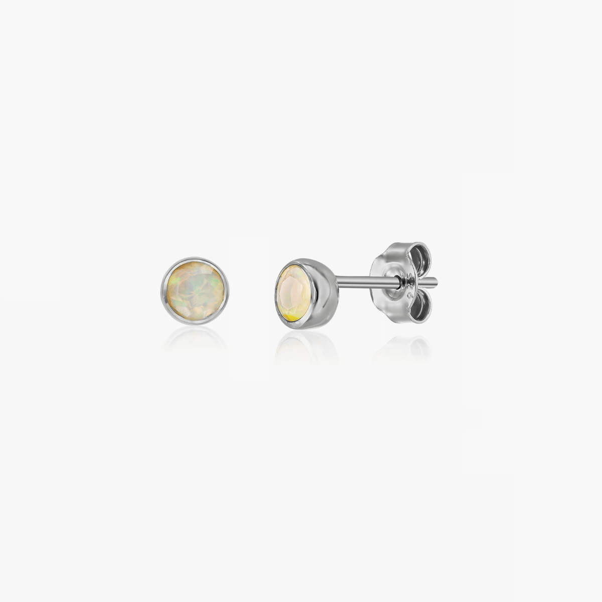 A pair of silver earrings with opal gemstones, designed as October birthstone studs.