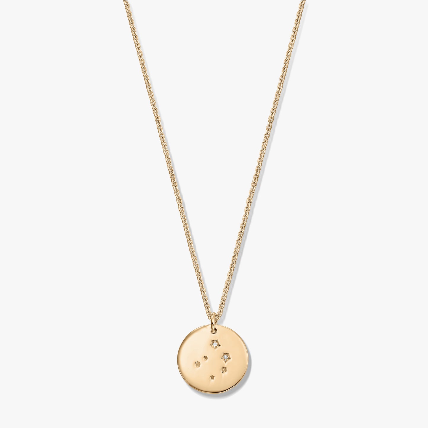 Gold‑tone Libra constellation disc pendant on a fine chain, photographed on a white background.