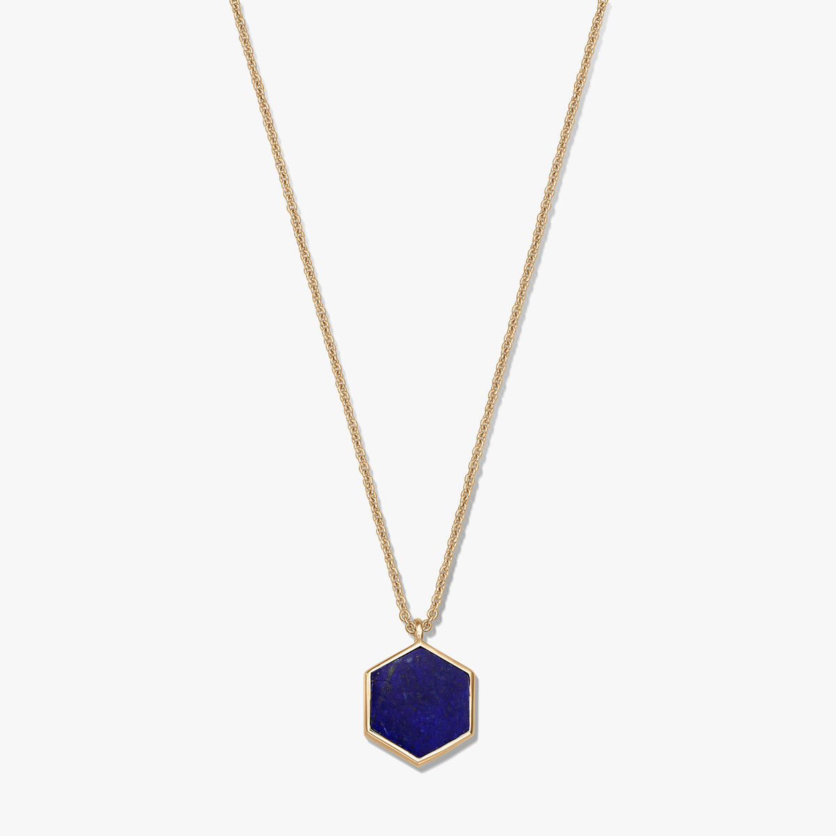 Gold-plated sterling silver necklace featuring a hexagonal lapis lazuli pendant on a white background.