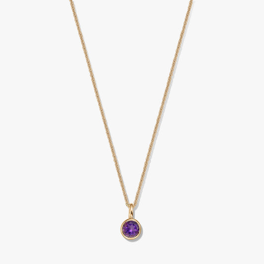 Gold-plated sterling silver necklace with a small round amethyst birthstone pendant on a white background.