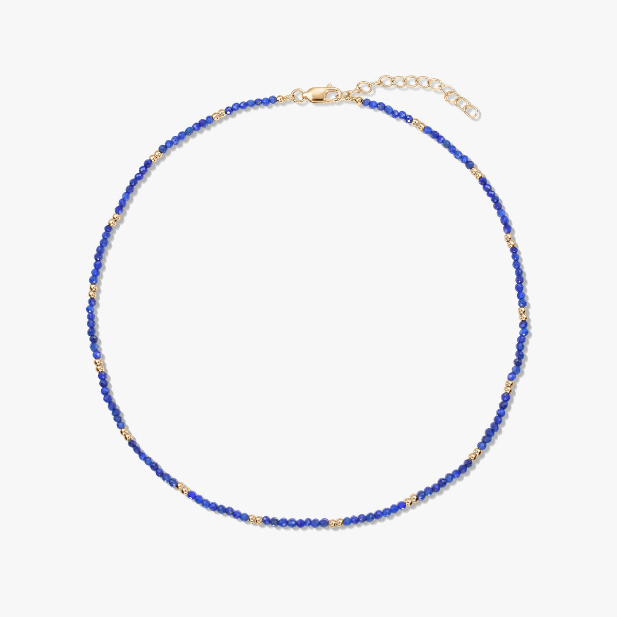 Delicate lapis lazuli beaded necklace with small gold‑plated sterling silver accents and an adjustable lobster clasp, isolated on a white background.