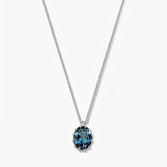 Elegant sterling silver necklace featuring an oval London blue topaz pendant on a white background.