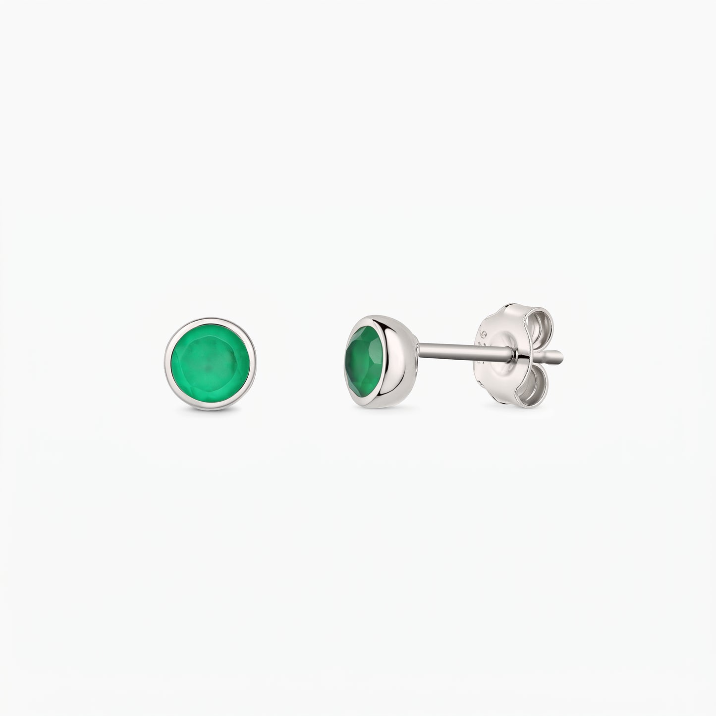 Elegant pair of silver stud earrings with bezel-set green onyx stones on a white background, shown from the front and side with butterfly backs.