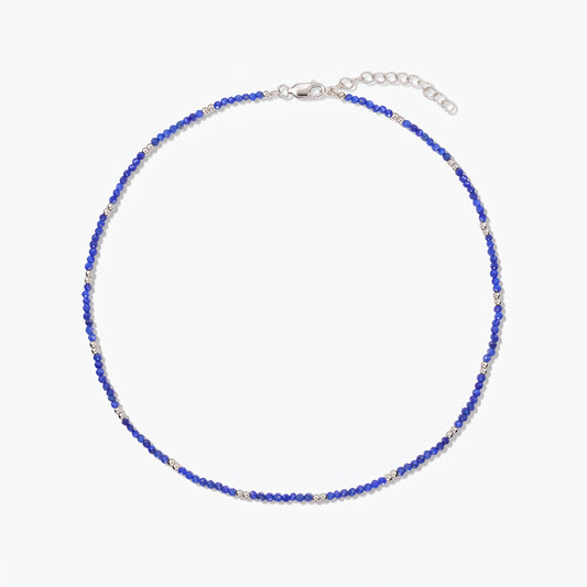 Indira SummerScape silver necklace with blue lapis lazuli beads, lobster clasp, and extender chain on a white background.